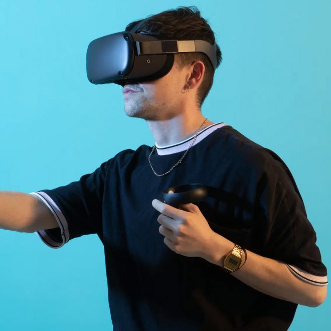 guy using virtual reality goggles against a blue background